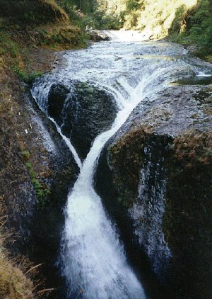 At the top of a waterfall, a wide rock bench is the perfect place to stop for lunch.